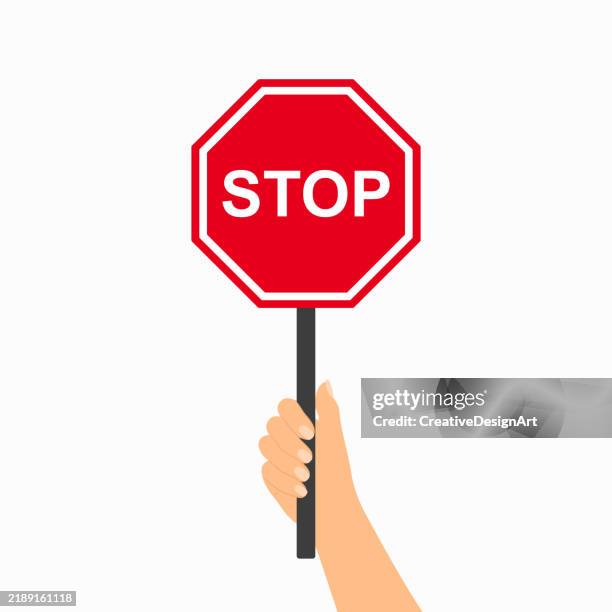 hand hält stopp straßenschild auf weißem hintergrund - stopschild stock-grafiken, -clipart, -cartoons und -symbole