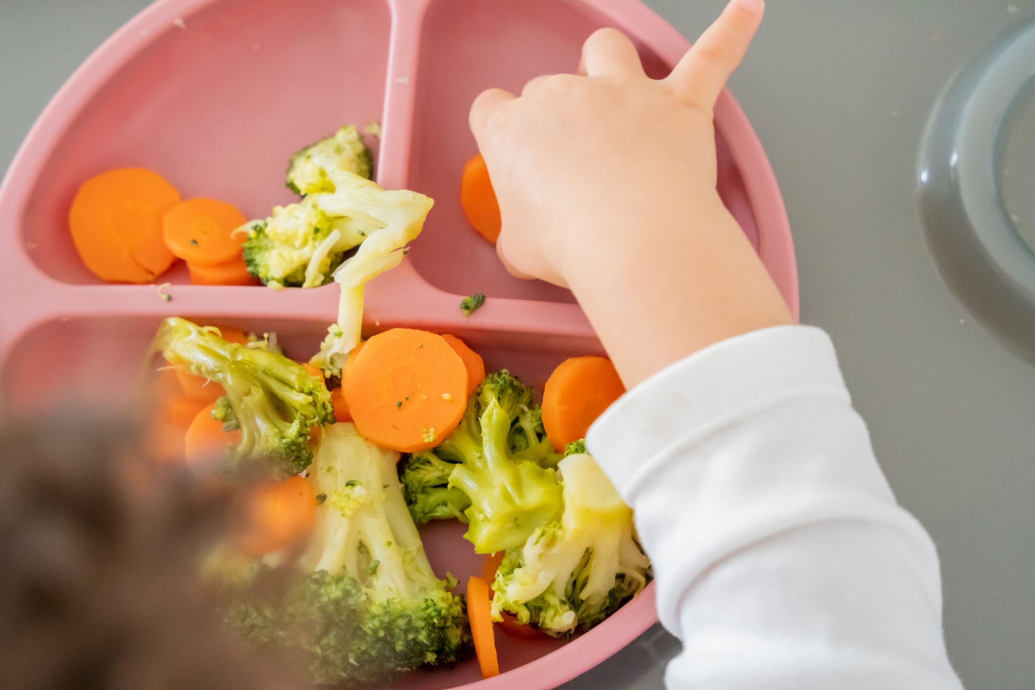 child eating vegetables