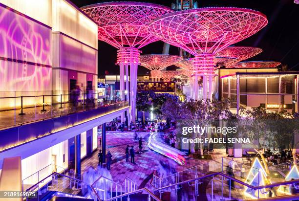 People walk at the Bluewater Island Wharf near Dubai Marina in Dubai on December 13, 2024.