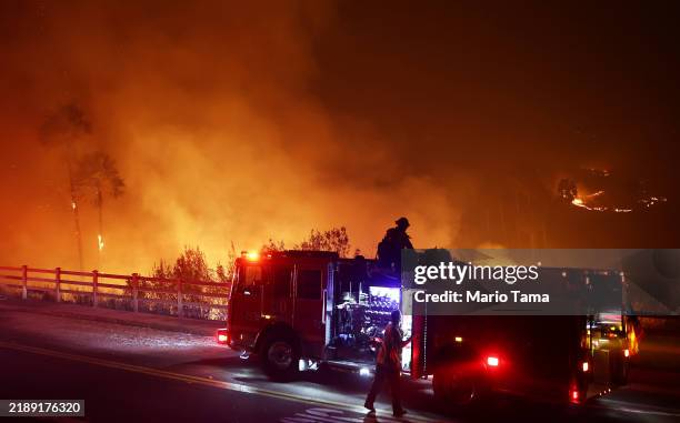 Firefighters work as the Franklin Fire burns on December 10, 2024 in Malibu, California. The wildfire has scorched 1,800 acres near Pepperdine...
