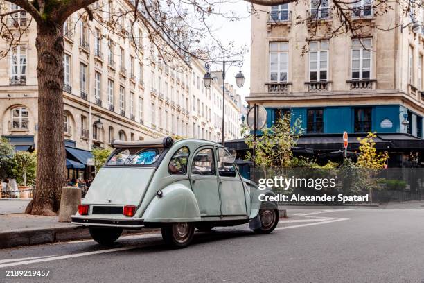 small vintage car on the street in latin quarter, paris, france - quartier latin stockfoto's en -beelden