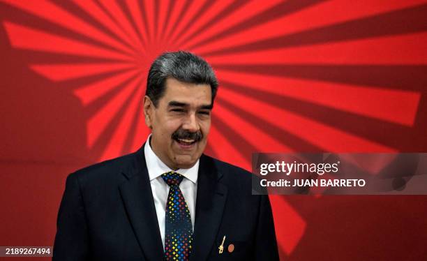 Venezuela's President Nicolas Maduro waves during the opening of the XXIV ALBA-TCP Summit in Caracas on December 14, 2024. The Bolivarian Alliance...
