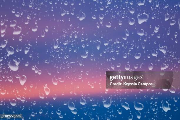 raindrops on window with sunset sky - dirty shower room stock pictures, royalty-free photos & images
