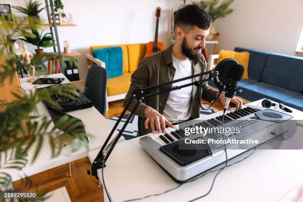 man enjoying playing electric piano - man playing piano stock pictures, royalty-free photos & images