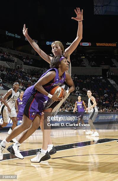Chantelle Anderson of the Sacramento Monarchs goes to the basket against Margo Dydek of the San Antonio Silver Stars during the game at SBC Center on...