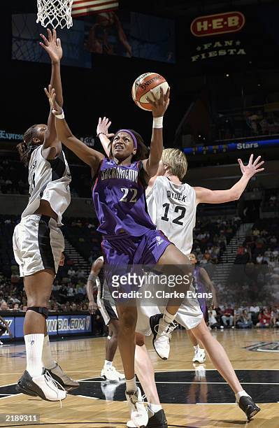 Chantelle Anderson of the Sacramento Monarchs goes to the basket past Margo Dydek and Gwen Jackson of the San Antonio Silver Stars during the game at...