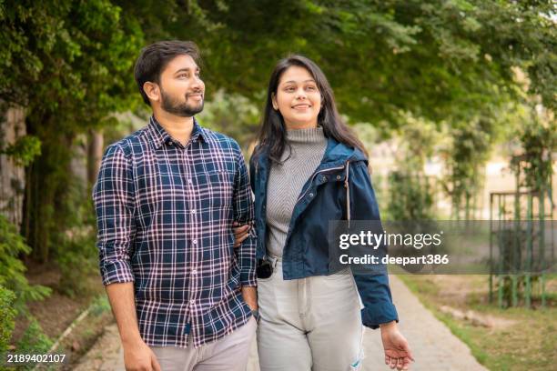 happy romantic indian young couple spending leisure time in the park. - south asia stock pictures, royalty-free photos & images