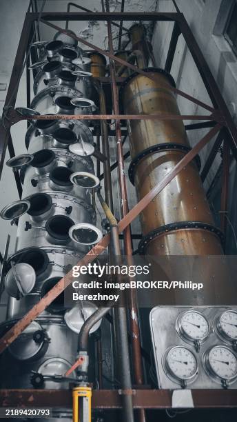 alembic at winery. stainless steel distillery tank at winery low angle view - destillation stock-fotos und bilder