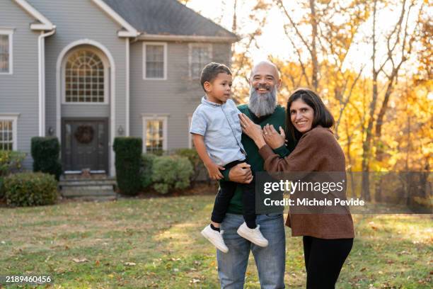 grandparents holding their grandson in front of the house - in front of stock pictures, royalty-free photos & images