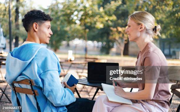 students engaging in outdoor study session at university campus - college dining stock pictures, royalty-free photos & images