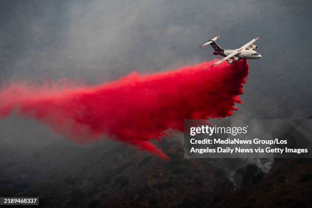 Malibu, CA An air tanker drops fire retardant on the Franklin fire in Malibu's Corral Canyon on Wednesday, December 11, 2024. Few structures were...