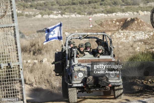 View of military vehicles patrolling the Syrian-Israeli border in the Majdal Shams area of the Golan Heights, as the Israeli army reinforces its...