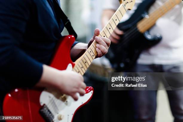 guitar player and bass player - bass gitarre stock-fotos und bilder