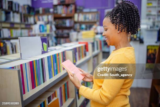 femme lisant un livre dans un cadre de librairie animé - reliure de livre photos et images de collection