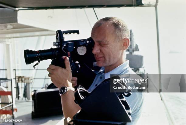 Apollo 11 astronaut Edwin Aldrin testing camera equipment aboard the NASA Motor Vessel 'Retriever' prior to participating in water egress training in...