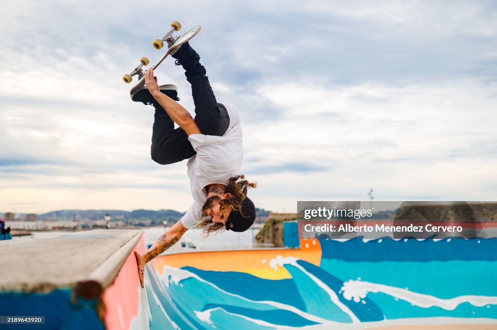 Skateboarder performing trick at cimadevilla skatepark in gijon