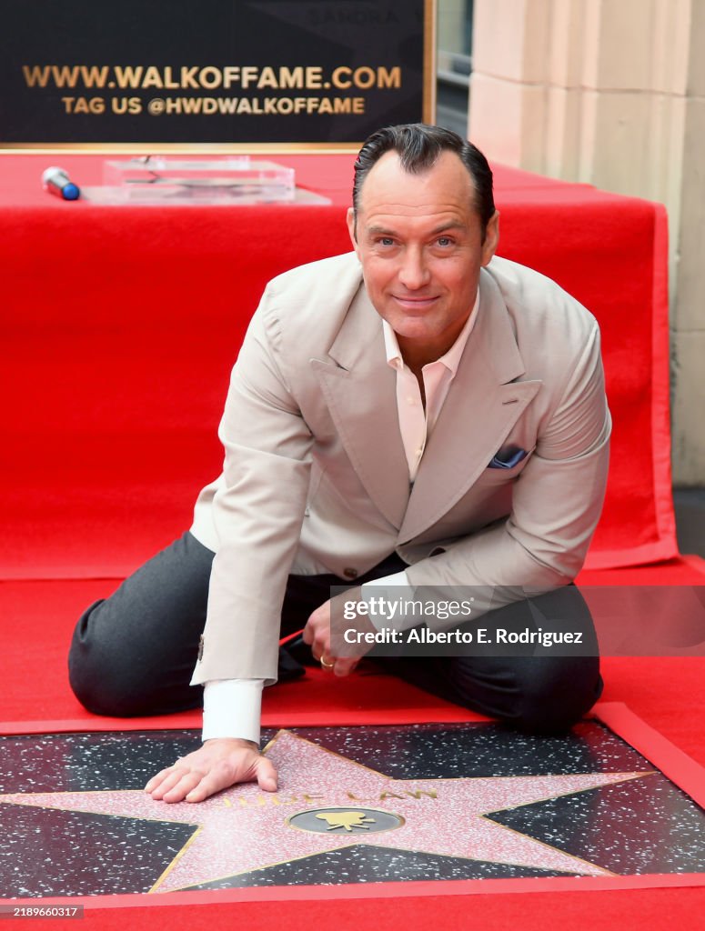Jude Law poses with his star during the Jude Law Star Ceremony on