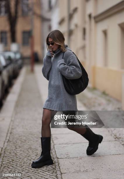 Sophia Geiss is seen wearing oval rimless black sunglasses from Vehla Eyewear; an oversized grey knit sweater with turtleneck from Black Palms; a...