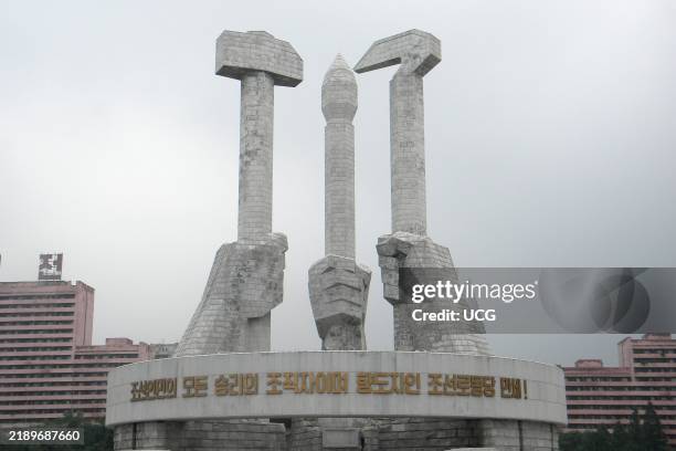 Members of the Korean workers party are educated at the Monument to Party Foundation which is hands holding a hammer a hoe. Symbol of Koryo....