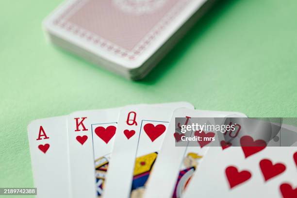 royal flush poker card sequence on a green table - suit stock pictures, royalty-free photos & images