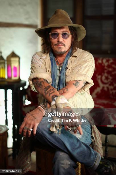 Johnny Depp poses during a photocall for "Modì, Three Days on the Wing of Madness" at the Red Sea International Film Festival 2024 on December 12,...