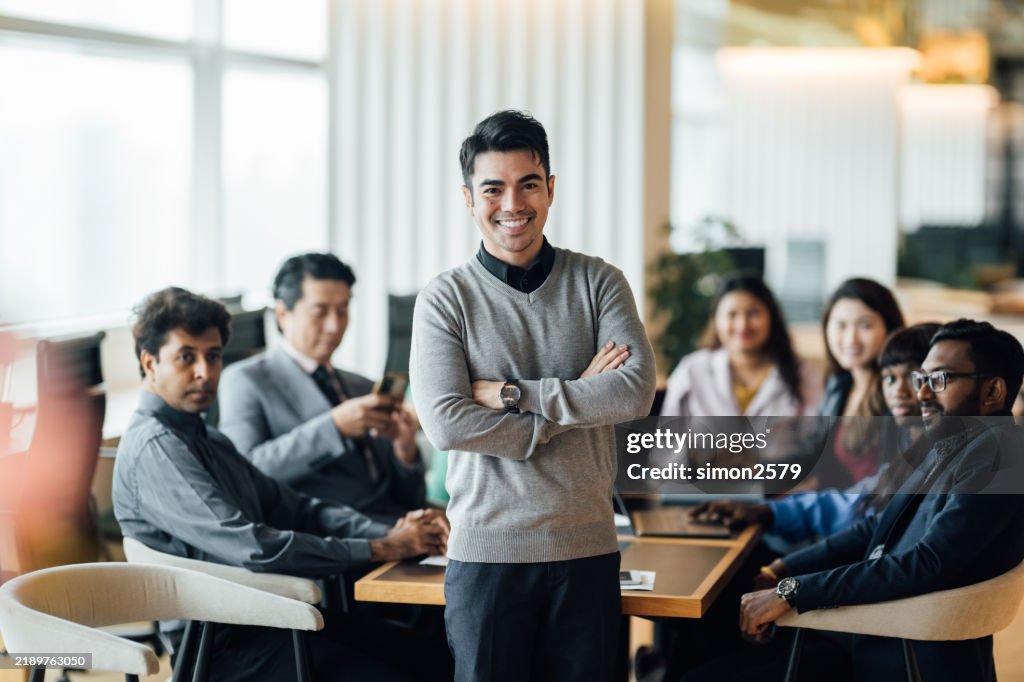 Empowering Leadership: A Young Team Leader Guiding His Team in a Modern Office
