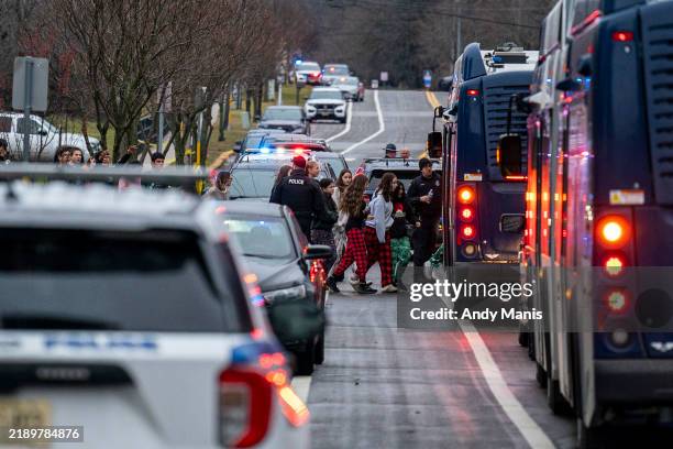 Students from Abundant Life Christian School are escorted to a city bus where they will reunited with their parents after a school shooting on...