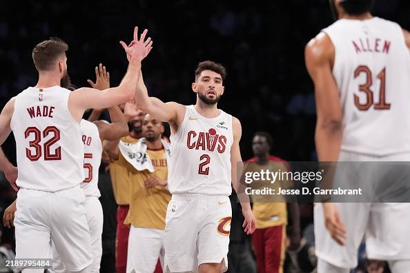Dean Wade and Ty Jerome of the Cleveland Cavaliers high five during