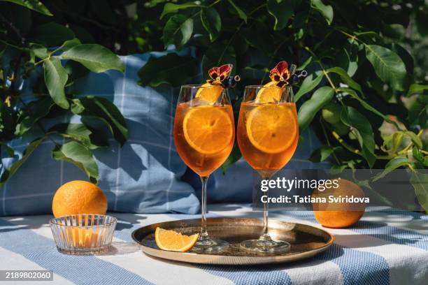 cocktail or mocktail, two glasses with orange garnish, spritz - aperol spritz stock pictures, royalty-free photos & images