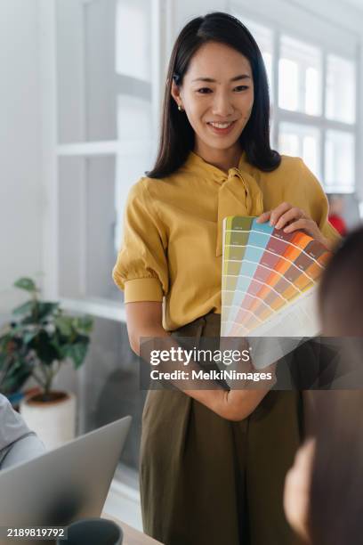interior designer holding color palette - interior designer stock pictures, royalty-free photos & images