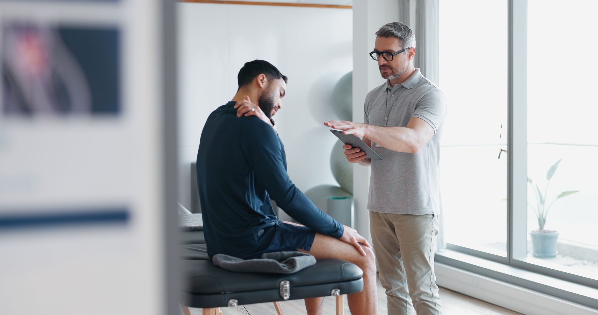chiropractor examining patient