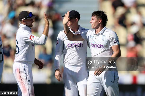Matthew Potts of England celebrates with Joe Root after dismissing Glenn Phillips of New Zealand during day one of the Third Test Match in the series...