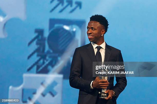Brazilian forward Vinicius Junior poses with the Best Player trophy during the Best FIFA Football Awards 2024 ceremony in Doha on December 17, 2024.