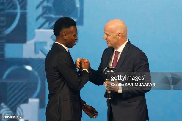 Brazilian forward Vinicius Junior receives the Best Player trophy from FIFA President Gianni Infantino during the Best FIFA Football Awards 2024...
