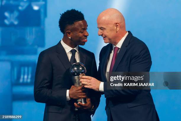 Brazilian forward Vinicius Junior receives the Best Player trophy from FIFA President Gianni Infantino during the Best FIFA Football Awards 2024...