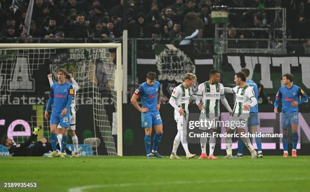Alassane Plea of Borussia Moenchengladbach celebrates scoring his team's fourth goal with teammates during the Bundesliga match between Borussia...