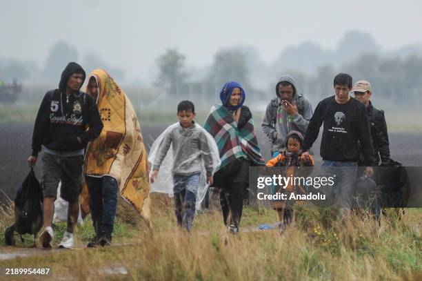 File photo dates September 10, 2015 shows Refugees arrive at a makeshift camp for asylum seekers near the border line between Serbia and Hungary in...