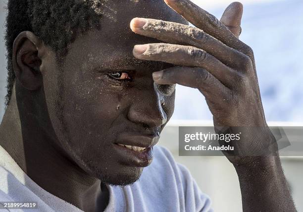 File photo dates March 13, 2015 shows An illegal migrant reacts at the coast of Souq al Jum'aa region in Tripoli, Libya after they got captured....