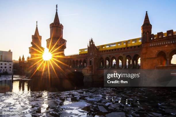 oberbaumbrücke with frozen spree river and passing subway train (friedrichshain-kreuzberg, berlin) - berlin winter stock pictures, royalty-free photos & images