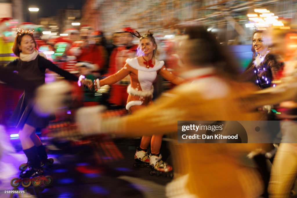 Hundreds Of Skating Santas Whizz Through Central London