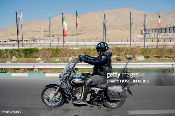 Motorcyclist with a Harley Davidson motorbike rides in Tehran, Iran, on November 29, 2024. The Harley Davidson riders' presence attracts public...