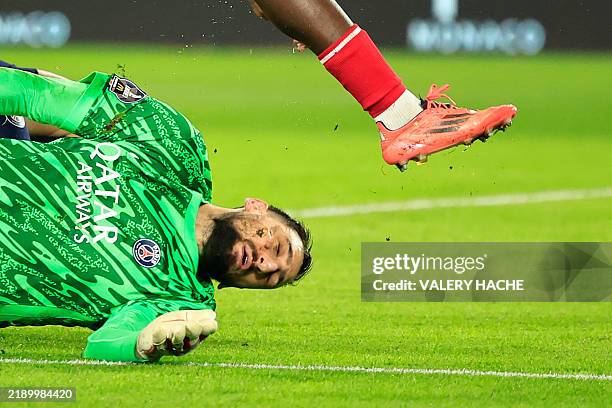 Paris Saint-Germain's Italian goalkeeper Gianluigi Donnarumma sustains an injury by Monaco's Ivorian defender Wilfried Singo during the French L1...