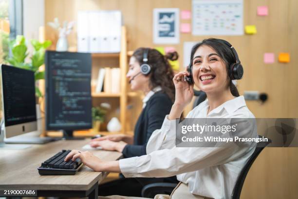 smiling professionals working in a collaborative modern office environment - workbench stock pictures, royalty-free photos & images