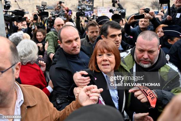 Gisele Pelicot arrives with her lawyers at the courthouse in Avignon on December 19 as the verdict is expected in the trial of her ex-husband, with...