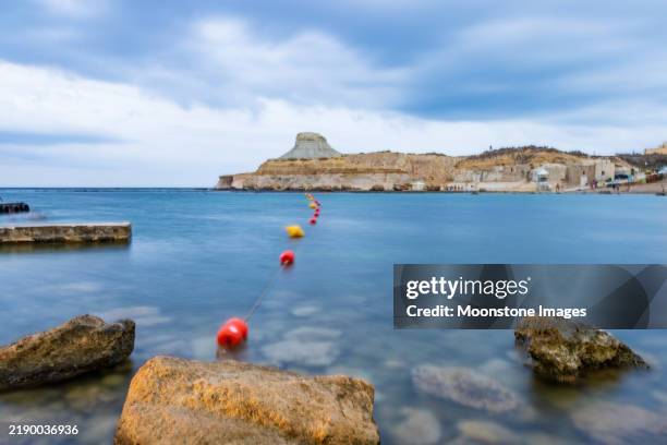 il-qolla l-bajda (the white hillock) at xwejni bay in gozo, malta - buoy stock pictures, royalty-free photos & images
