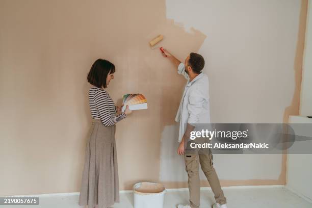 couple renovating and choosing paint colors for their home - real couple stock pictures, royalty-free photos & images