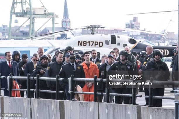 Luigi Mangione, suspect in the killing of UnitedHealthcare CEO Brian Thompson in New York City, arrives at a heliport with members of the NYPD on...