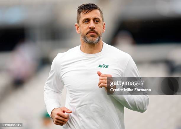 Aaron Rodgers of the New York Jets warms up before the game against the Jacksonville Jaguars at EverBank Stadium on December 15, 2024 in...
