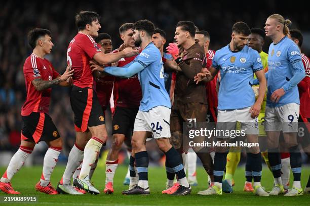 Harry Maguire of Manchester United and Erling Haaland of Manchester City clash following an altercation between Kyle Walker of Manchester City and...
