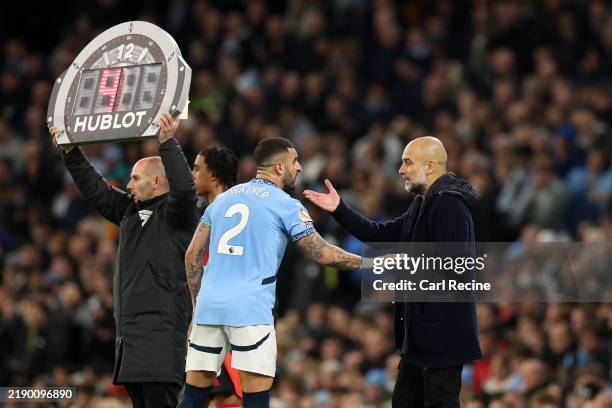 Kyle Walker of Manchester City speaks with Pep Guardiola, Manager of Manchester City, during the Premier League match between Manchester City FC and...